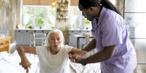 social-worker-taking-care-old-woman-1-300×200